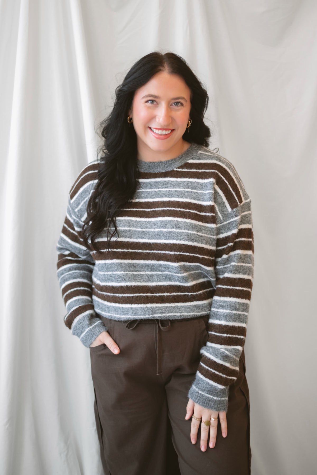 Abbie Striped Crew Neckline Long Sleeve Cropped Knit Sweater in Brown Multi with a warm neutral stripe pattern.