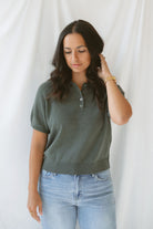 Close up view of model wearing the short sleeve polo sweater. A soft and polished option for a put together outfit. 