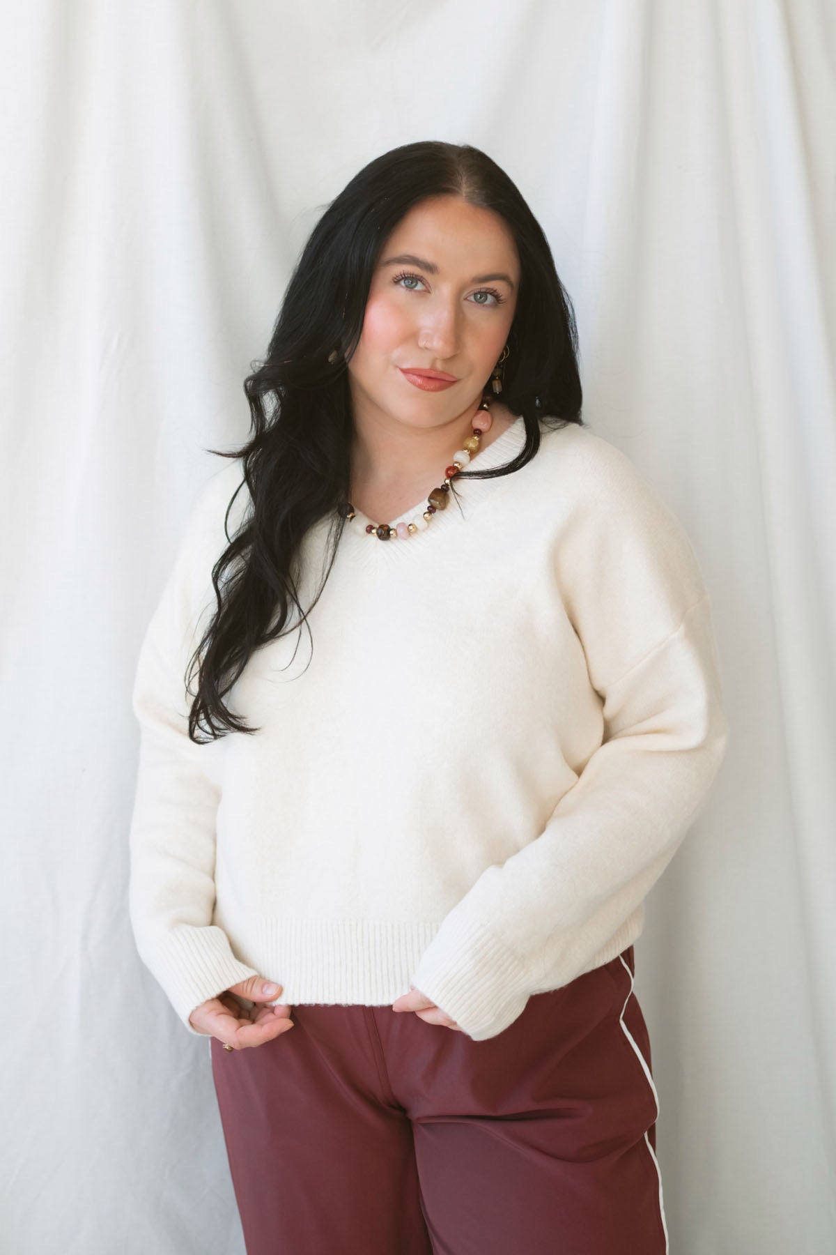 Drew Cream Brushed Knit V-Neck Pullover Sweater for women featuring a soft textured knit, classic V-neckline, and long sleeves for cozy everyday styling.