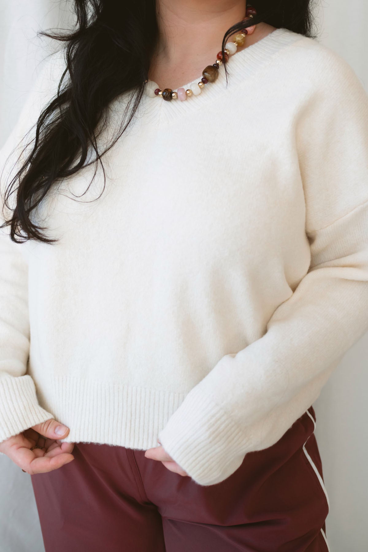 Drew Cream Brushed Knit V-Neck Pullover Sweater for women featuring a soft textured knit, classic V-neckline, and long sleeves for cozy everyday styling.