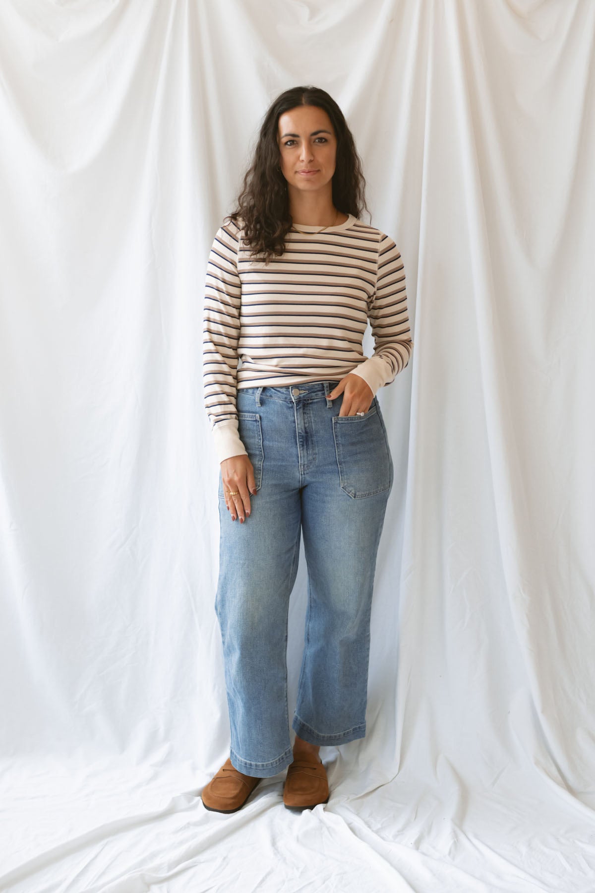 Model wearing the cream stripe long sleeve top. 
