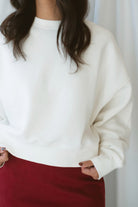 Model wearing balloon sleeve detail sweatshirt. 