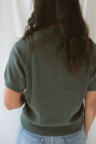 Back view of model wearing the short sleeve polo sweater. A soft and polished option for a put together outfit. 
