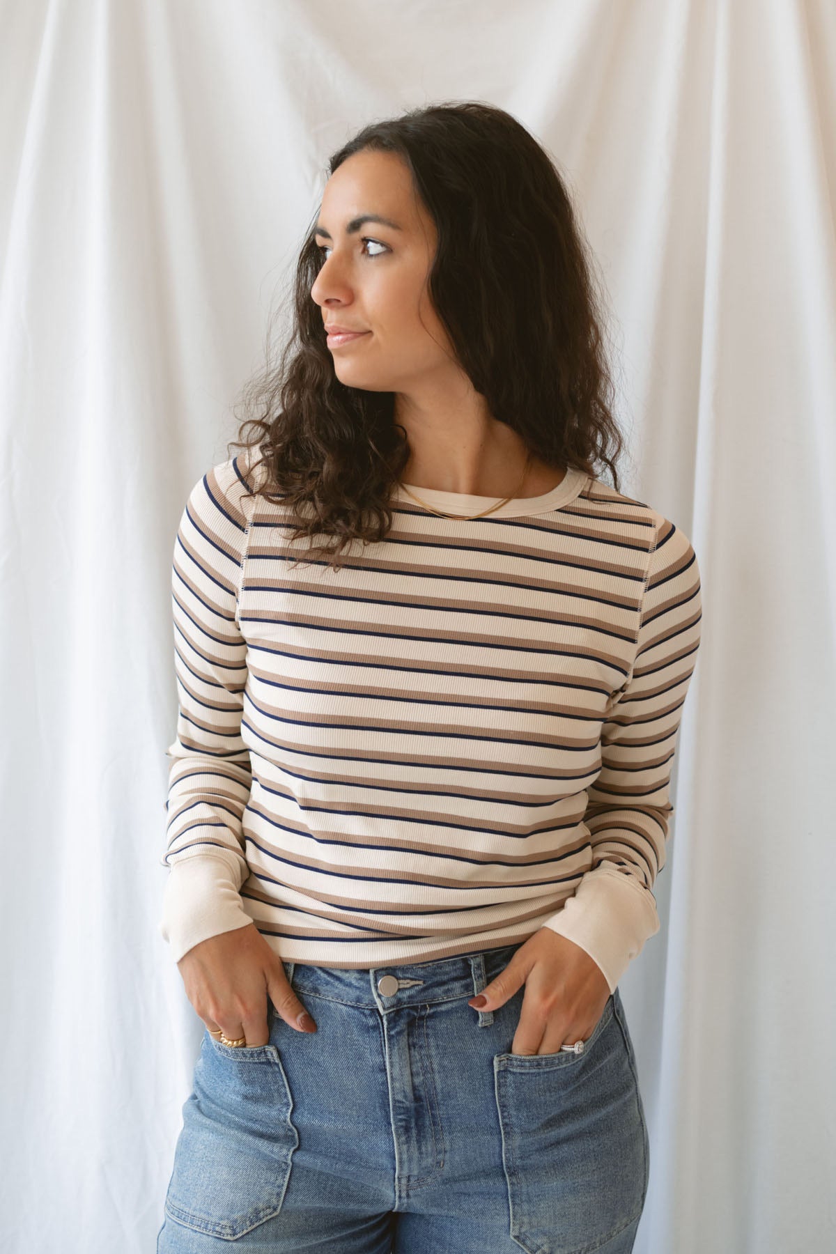 Model wearing the cream stripe long sleeve top. 