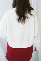 Model wearing balloon sleeve detail sweatshirt. 