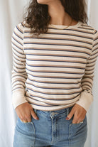 Model wearing the cream stripe long sleeve top. 