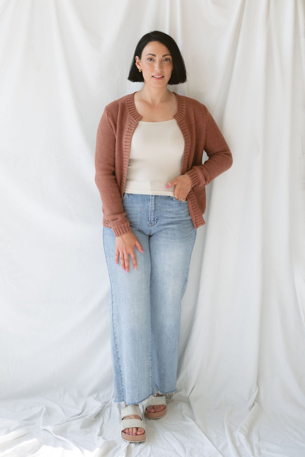 Model is wearing the ribbed edge open cardigan. Paired with a basic cream tank and a pair of denim. This cardigan is great from season to season. 