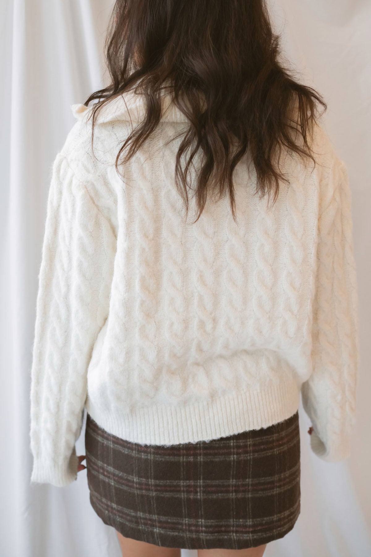 Madison High Neck Cable Fuzzy Knit Zip Up Cardigan in Cream featuring a high neckline, textured cable knit pattern, and zip-front closure.