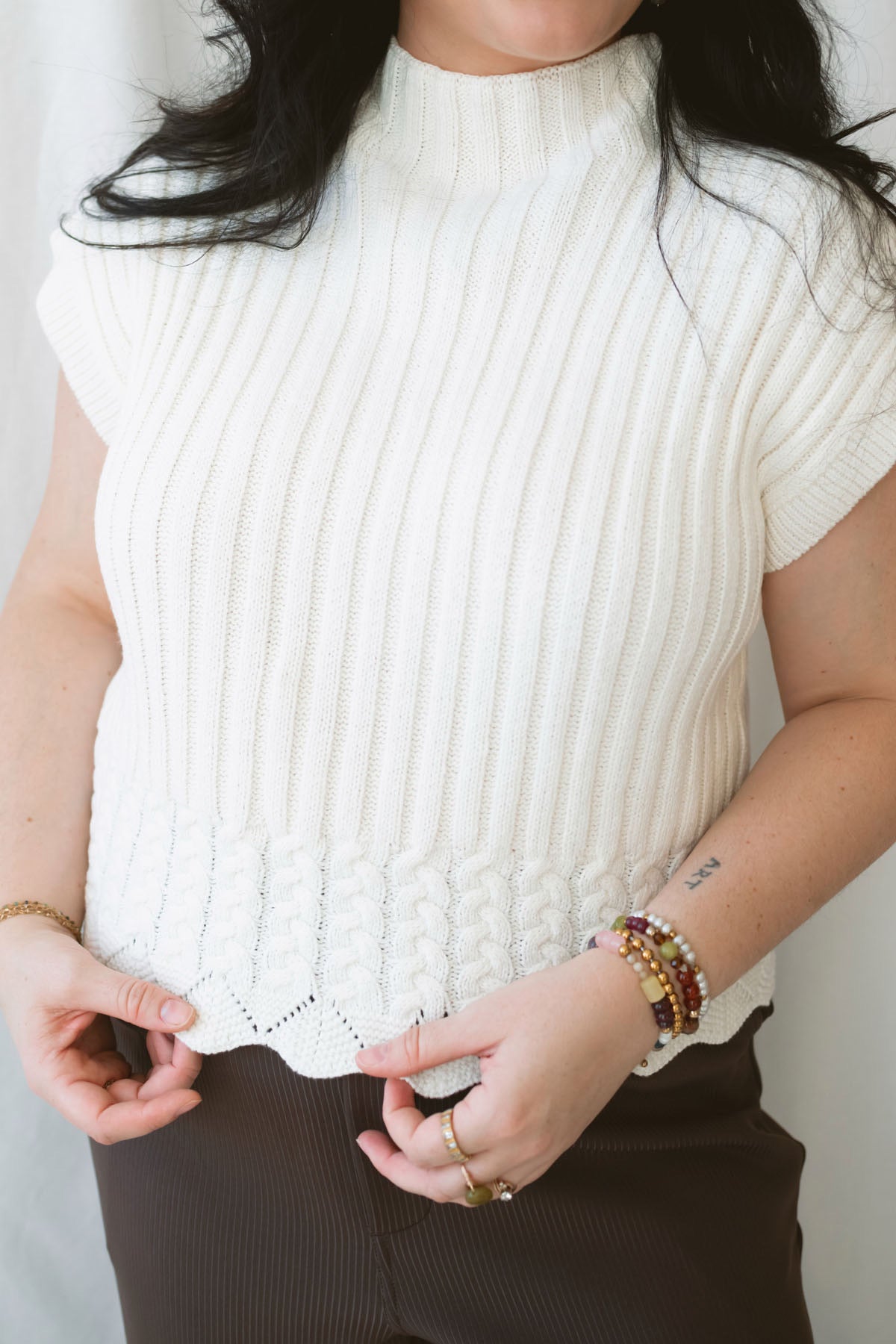 Rory Ivory short sleeve turtleneck sweater vest for women, featuring a creamy neutral knit design and cozy high neckline for casual fall outfits.