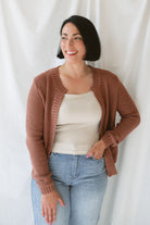 Model is wearing the ribbed edge open cardigan. Paired with a basic cream tank and a pair of denim. This cardigan is great from season to season. 