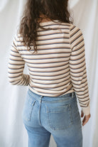 Model wearing the cream stripe long sleeve top. 