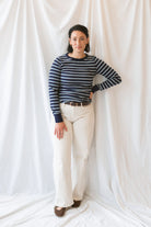 Model wearing the stripe long sleeve top in dark navy.