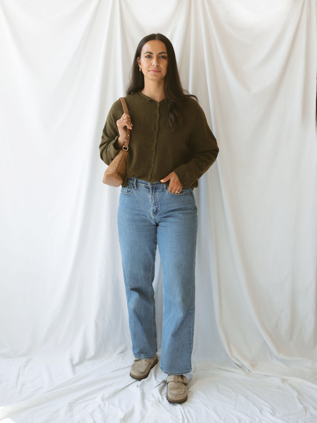 Model wearing full button up cardigan in olive. Cardigan is a great versatile option, because you can wear it fully buttoned up as a sweater or unbuttoned as a cardigan.