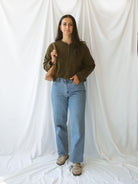 Model wearing full button up cardigan in olive. Cardigan is a great versatile option, because you can wear it fully buttoned up as a sweater or unbuttoned as a cardigan.