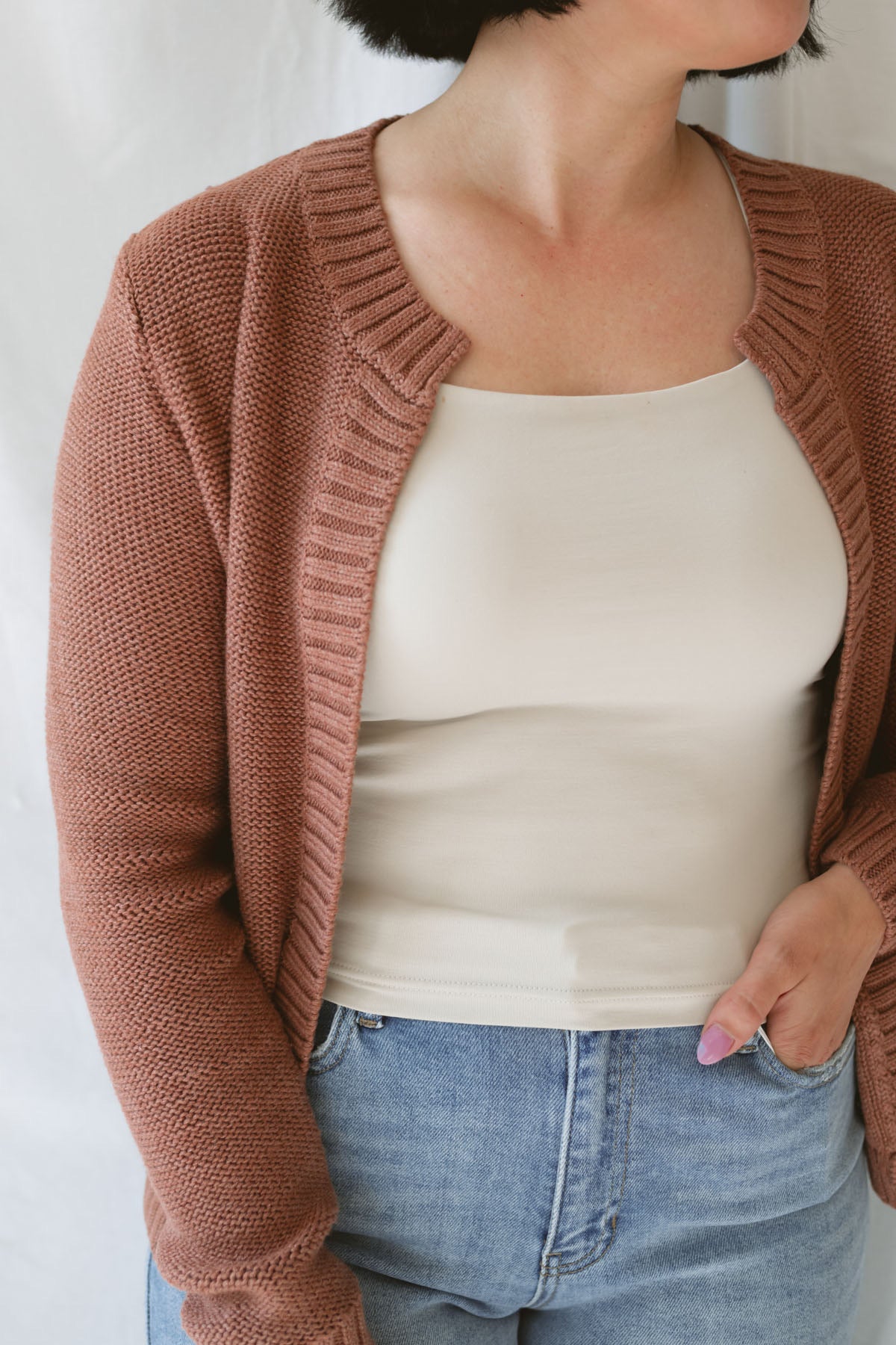 Model is wearing the ribbed edge open cardigan. Paired with a basic cream tank and a pair of denim. This cardigan is great from season to season. 