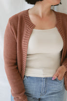Model is wearing the ribbed edge open cardigan. Paired with a basic cream tank and a pair of denim. This cardigan is great from season to season. 
