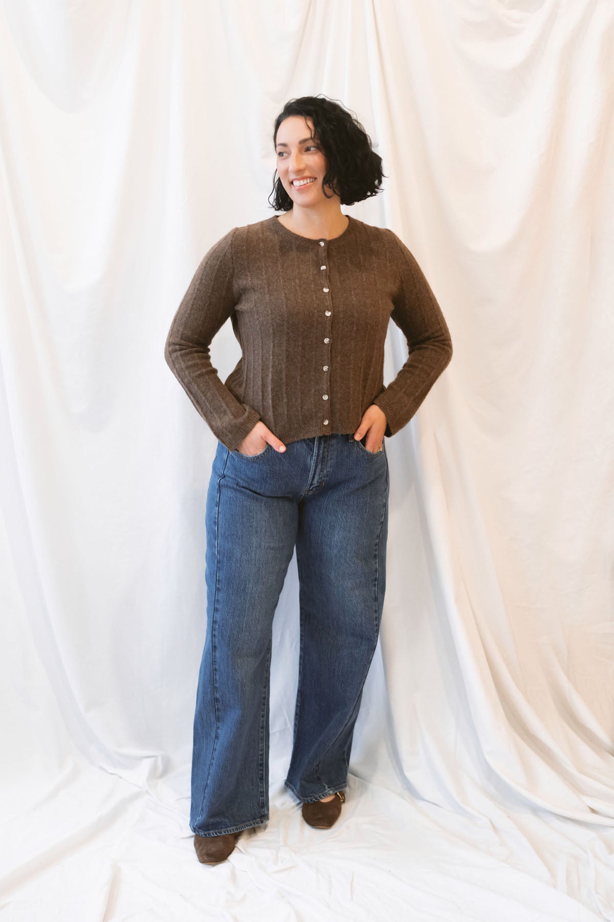 Chocolate brown rib knit cardigan for women featuring delicate ruffle trim, textured ribbed fabric, and a feminine design for elevated fall and winter styling.