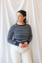 Model wearing the stripe long sleeve top in dark navy.
