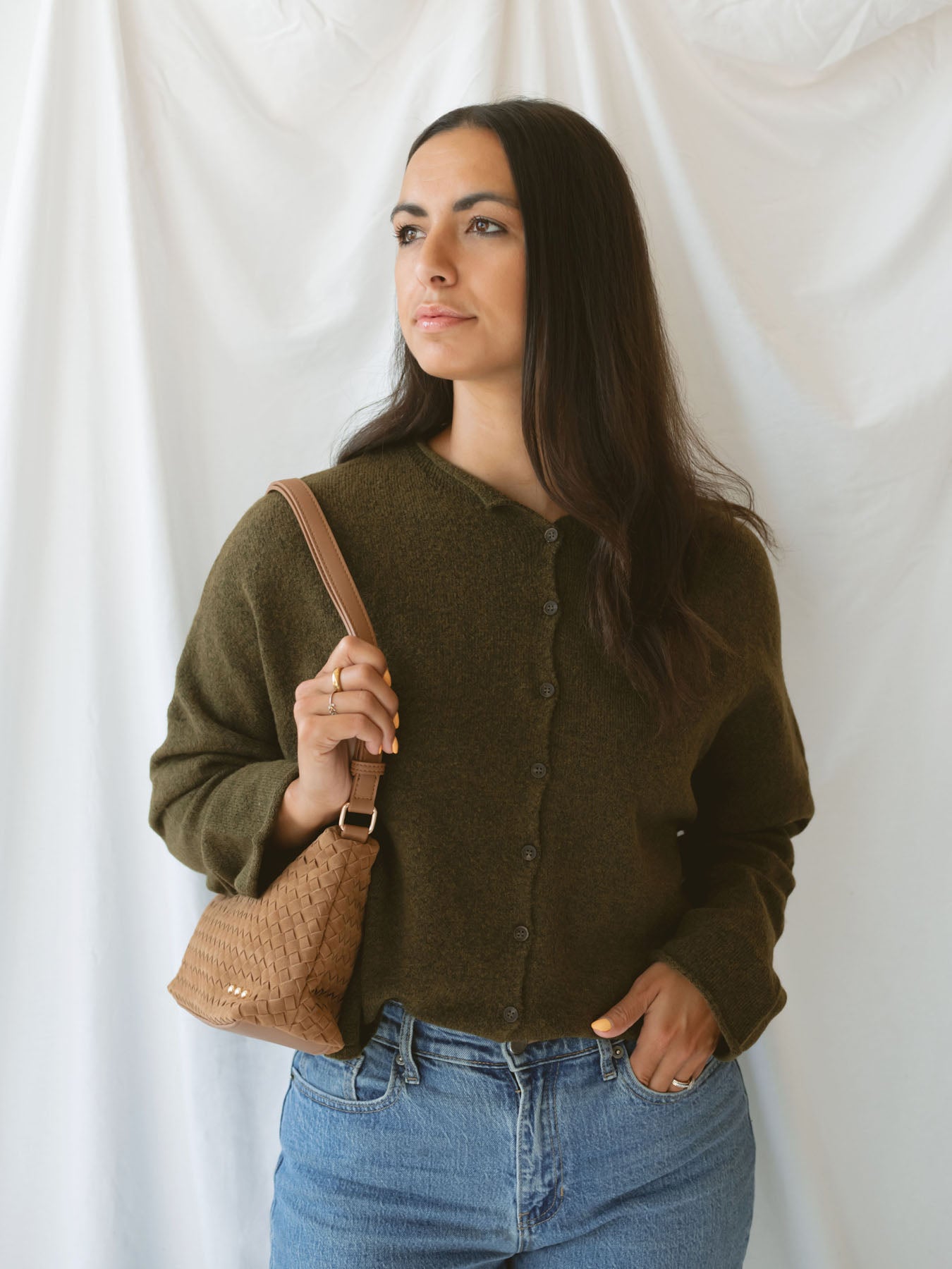 Model wearing full button up cardigan in olive. Cardigan is a great versatile option, because you can wear it fully buttoned up as a sweater or unbuttoned as a cardigan.
