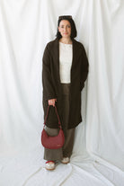 Carrie women's soft long coat in Brown featuring a classic extended-length silhouette and long sleeves for stylish fall and winter layering.