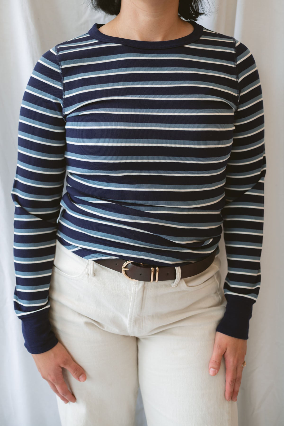 Model wearing the stripe long sleeve top in dark navy.