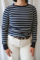 Model wearing the stripe long sleeve top in dark navy.