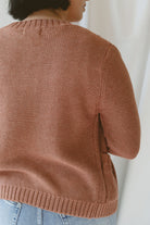Back view of model wearing the ribbed edge open cardigan. Paired with a basic cream tank and a pair of denim. This cardigan is great from season to season. 