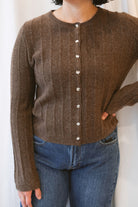 Chocolate brown rib knit cardigan for women featuring delicate ruffle trim, textured ribbed fabric, and a feminine design for elevated fall and winter styling.