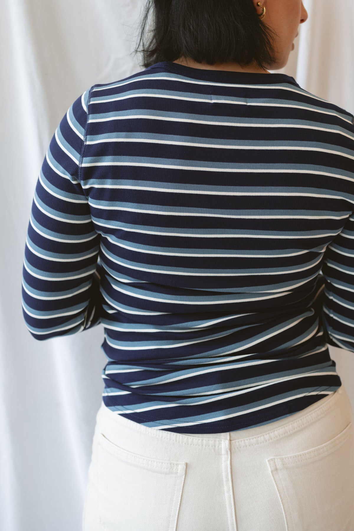 Model wearing the stripe long sleeve top in dark navy.