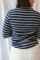 Model wearing the stripe long sleeve top in dark navy.