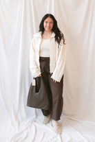 Madison High Neck Cable Fuzzy Knit Zip Up Cardigan in Cream featuring a high neckline, textured cable knit pattern, and zip-front closure.