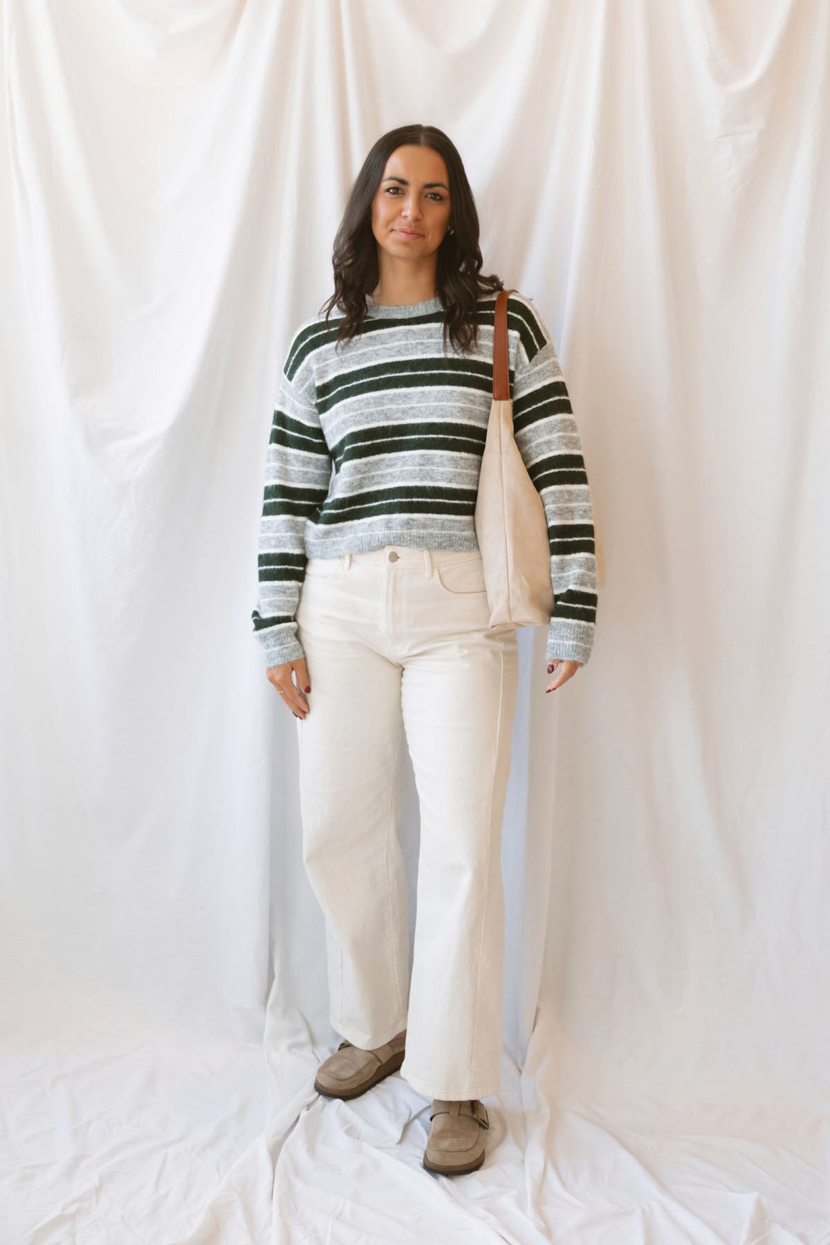 Abbie hunter green multi striped cropped knit sweater with a crew neckline and long sleeves.