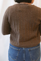 Chocolate brown rib knit cardigan for women featuring delicate ruffle trim, textured ribbed fabric, and a feminine design for elevated fall and winter styling.