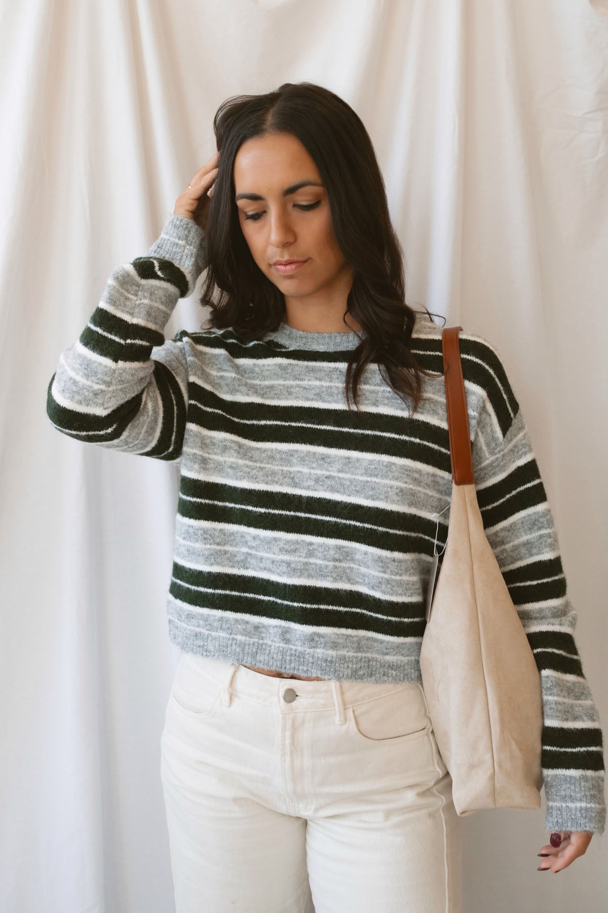 Abbie hunter green multi striped cropped knit sweater with a crew neckline and long sleeves.