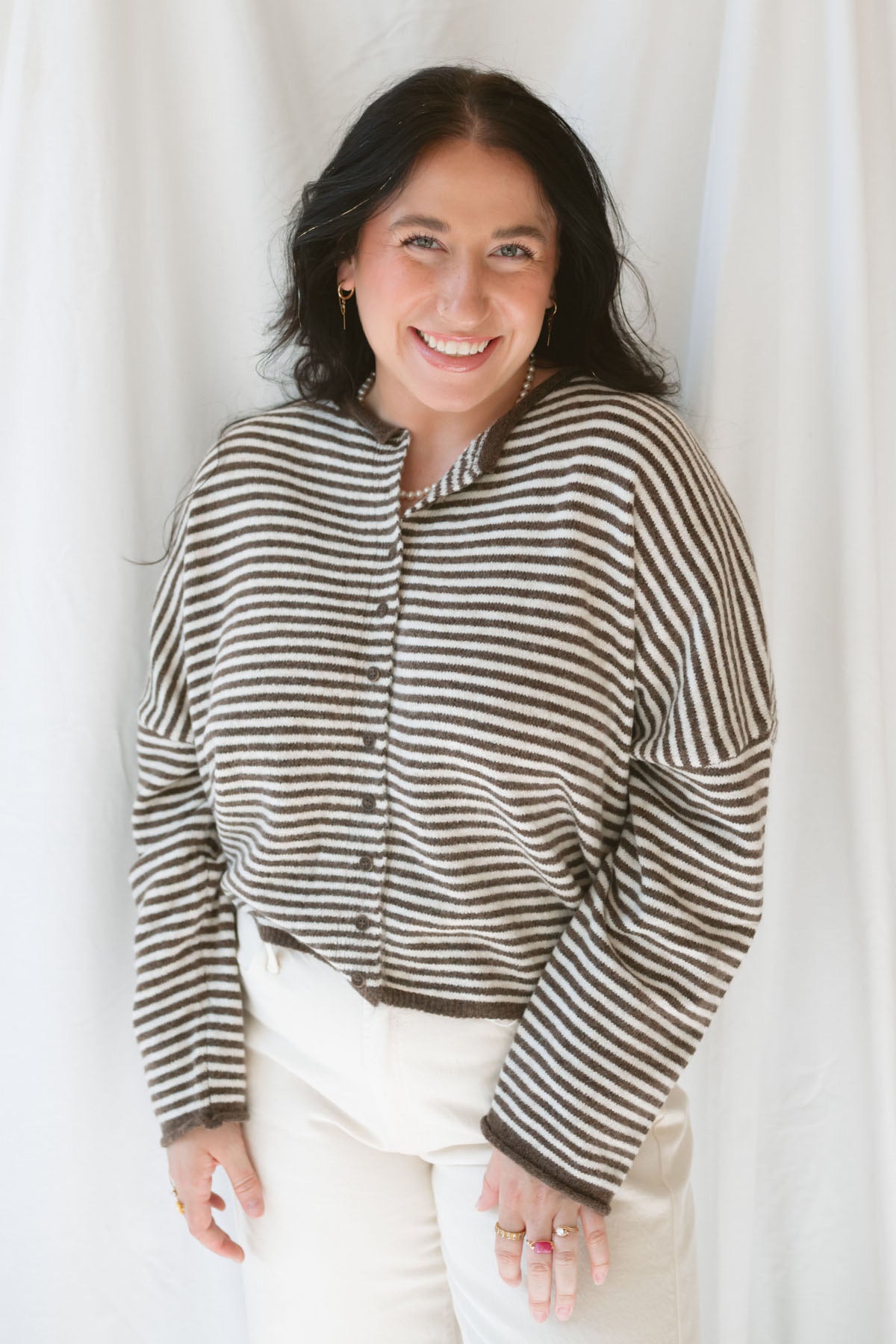 Model wearing the stripe drop shoulder long sleeve cardigan. This cardigan layers well over many tanks and shirts or you can wear it fully buttoned up as a top. Easy to transition form season to season. 