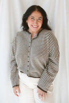 Model wearing the stripe drop shoulder long sleeve cardigan. This cardigan layers well over many tanks and shirts or you can wear it fully buttoned up as a top. Easy to transition form season to season. 