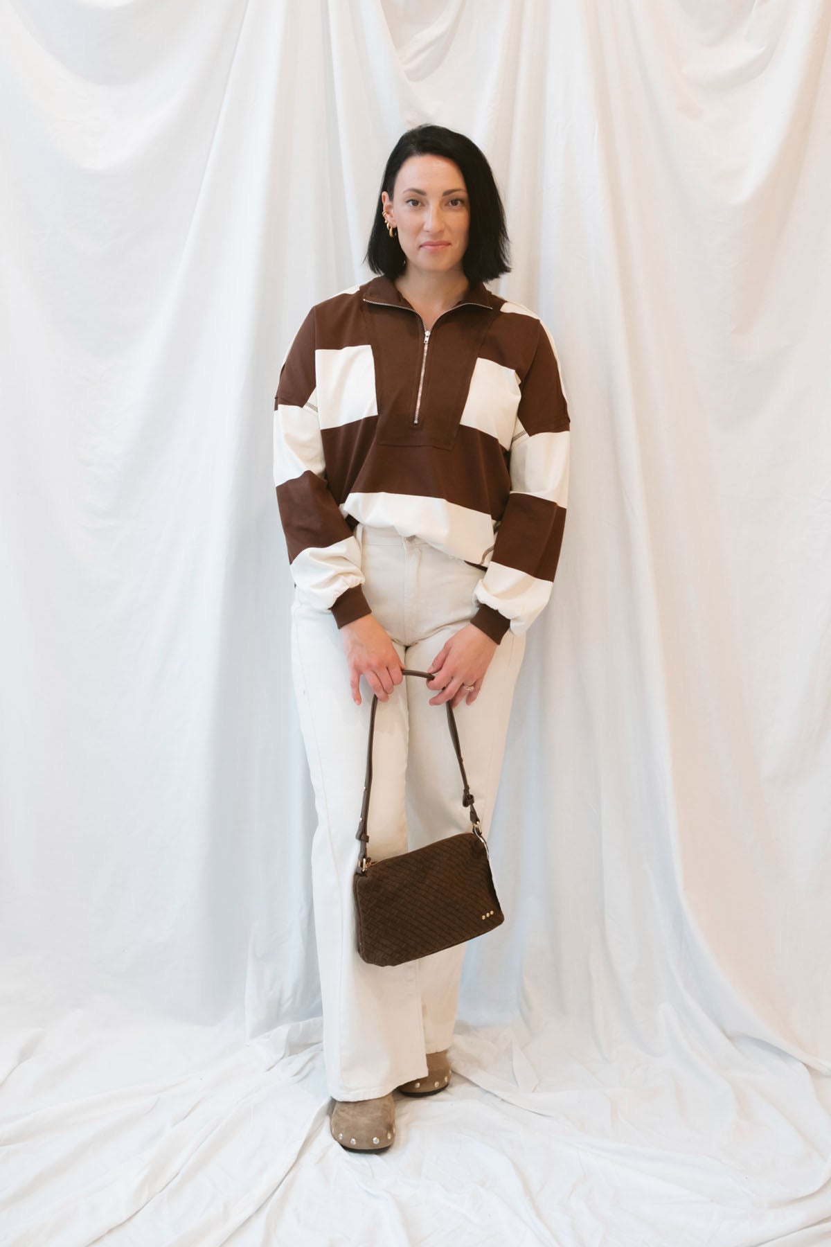 Model wearing half zip pullover sweatshirt. 