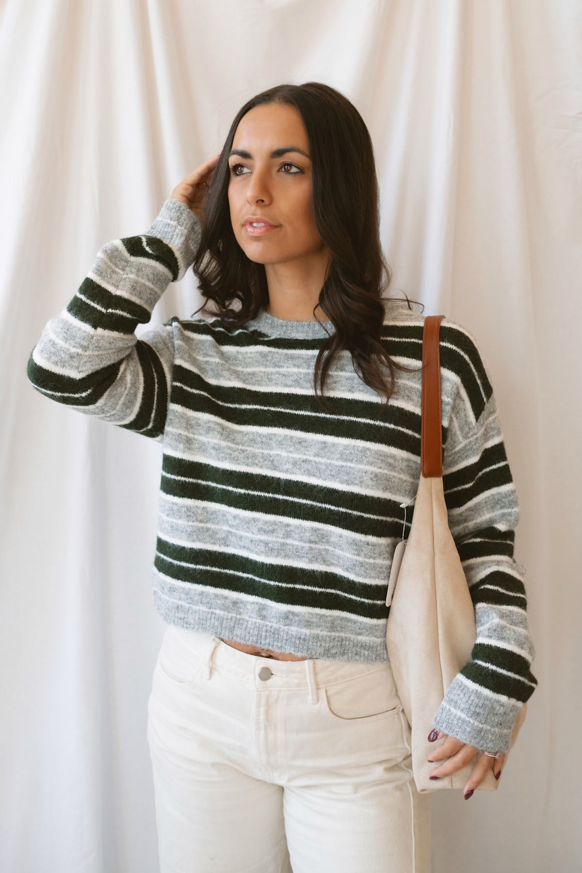 Abbie hunter green multi striped cropped knit sweater with a crew neckline and long sleeves.