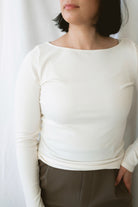 Brynley women's Vanilla micro ribbed long sleeve top featuring a feminine boat neckline and soft cream color for casual everyday styling.