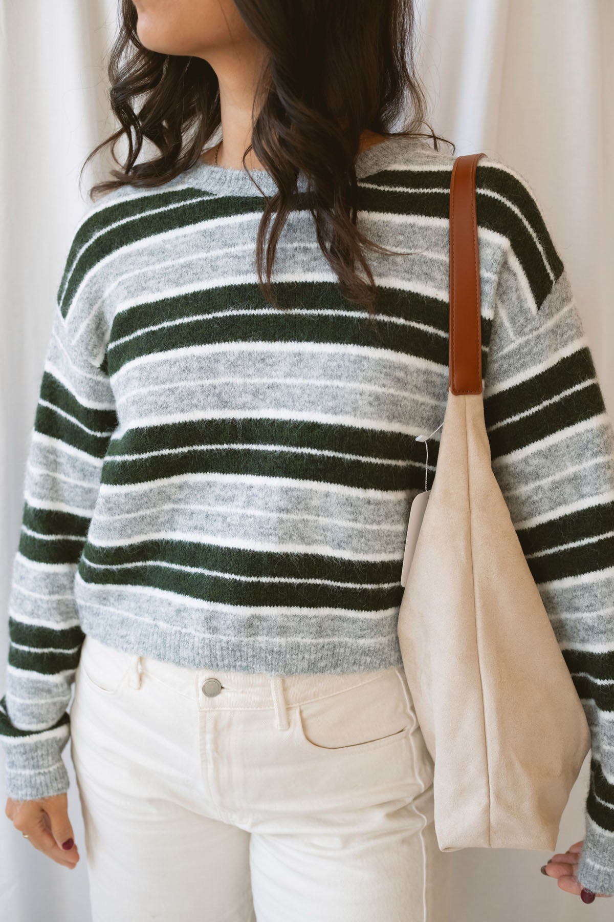 Abbie hunter green multi striped cropped knit sweater with a crew neckline and long sleeves.