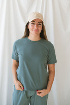 Model is wearing a classic boxy fit tee in the color eucalyptus green. 