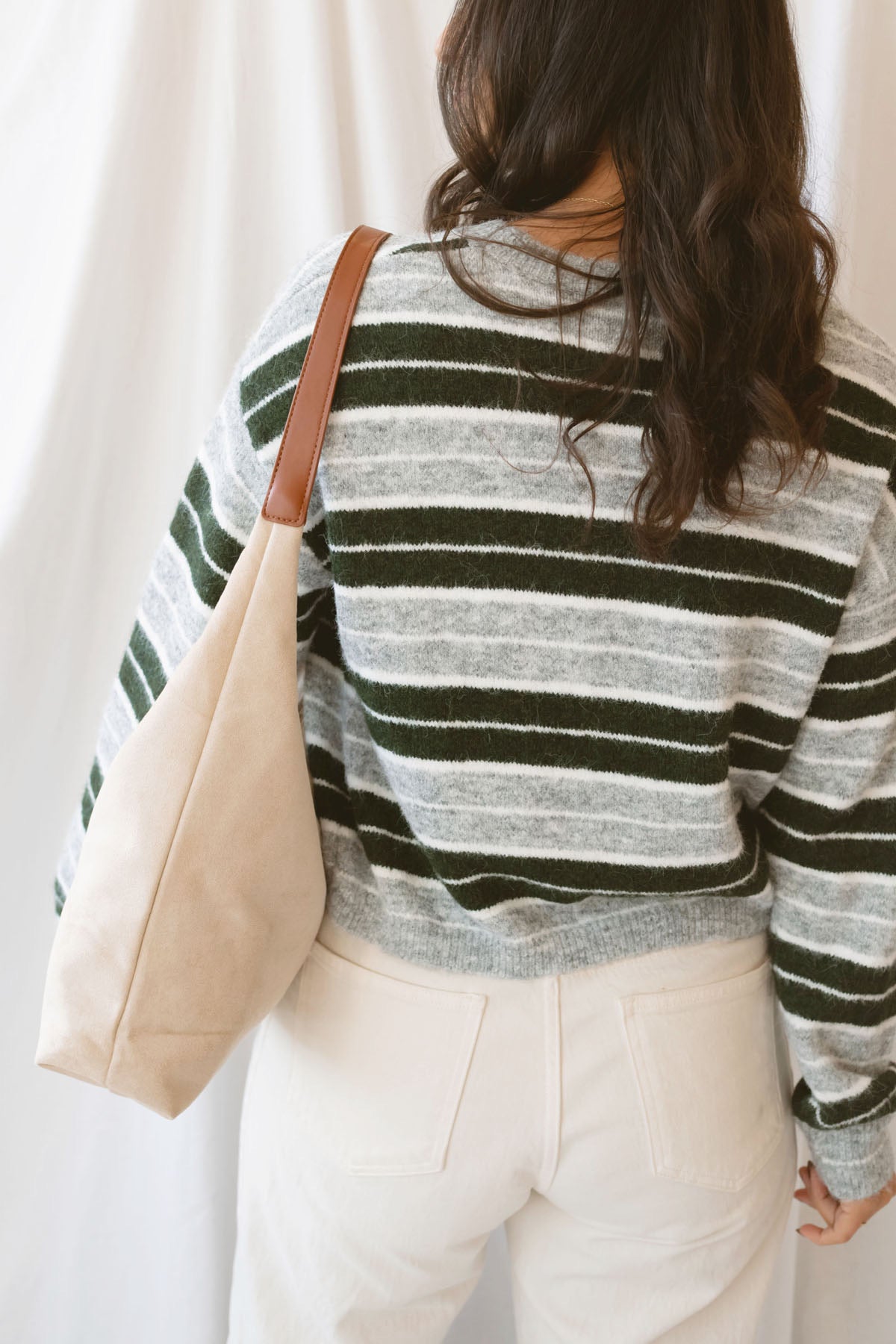 Abbie hunter green multi striped cropped knit sweater with a crew neckline and long sleeves.