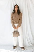 Model wearing long sleeve raw edge knit sweater. Paired with shorts during the summer or pants heading into the cooler seasons makes this a great staple season after season. 