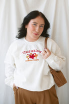 Model is wearing the embroidered stars hollow sweatshirt.