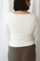 Brynley women's Vanilla micro ribbed long sleeve top featuring a feminine boat neckline and soft cream color for casual everyday styling.