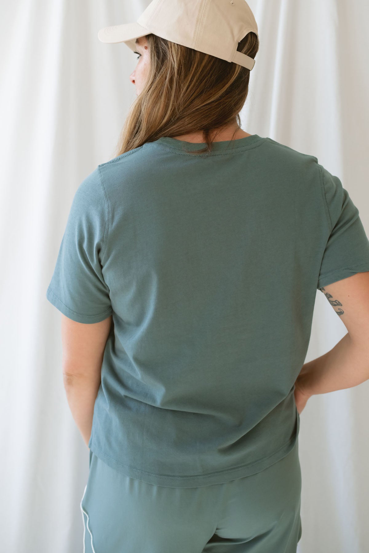 Model is wearing a classic boxy fit tee in the color eucalyptus green. 