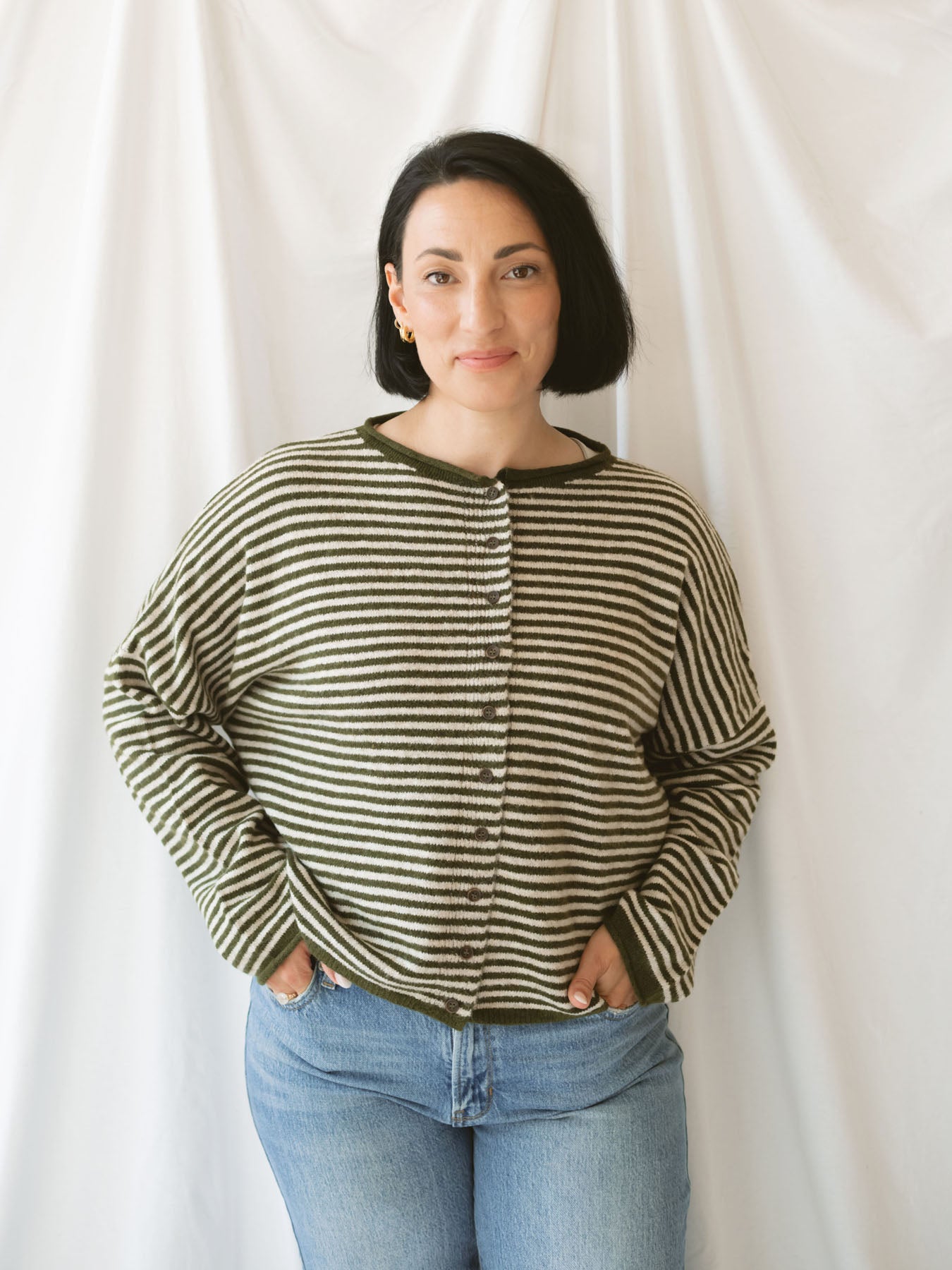 Model wearing striped full button cardigan. Styled fully buttoned up with a pair of classic denim. 