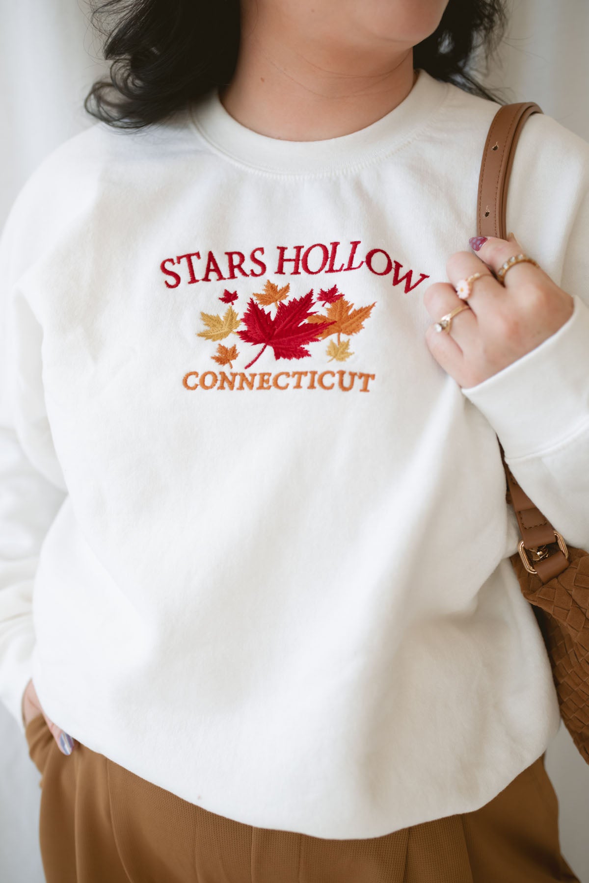 Model is wearing the embroidered stars hollow sweatshirt.