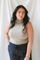 Model is wearing sleeveless knit turtleneck top styled with the Jude Check Woven Pants. Outfit is tailored and great for many occasions. 