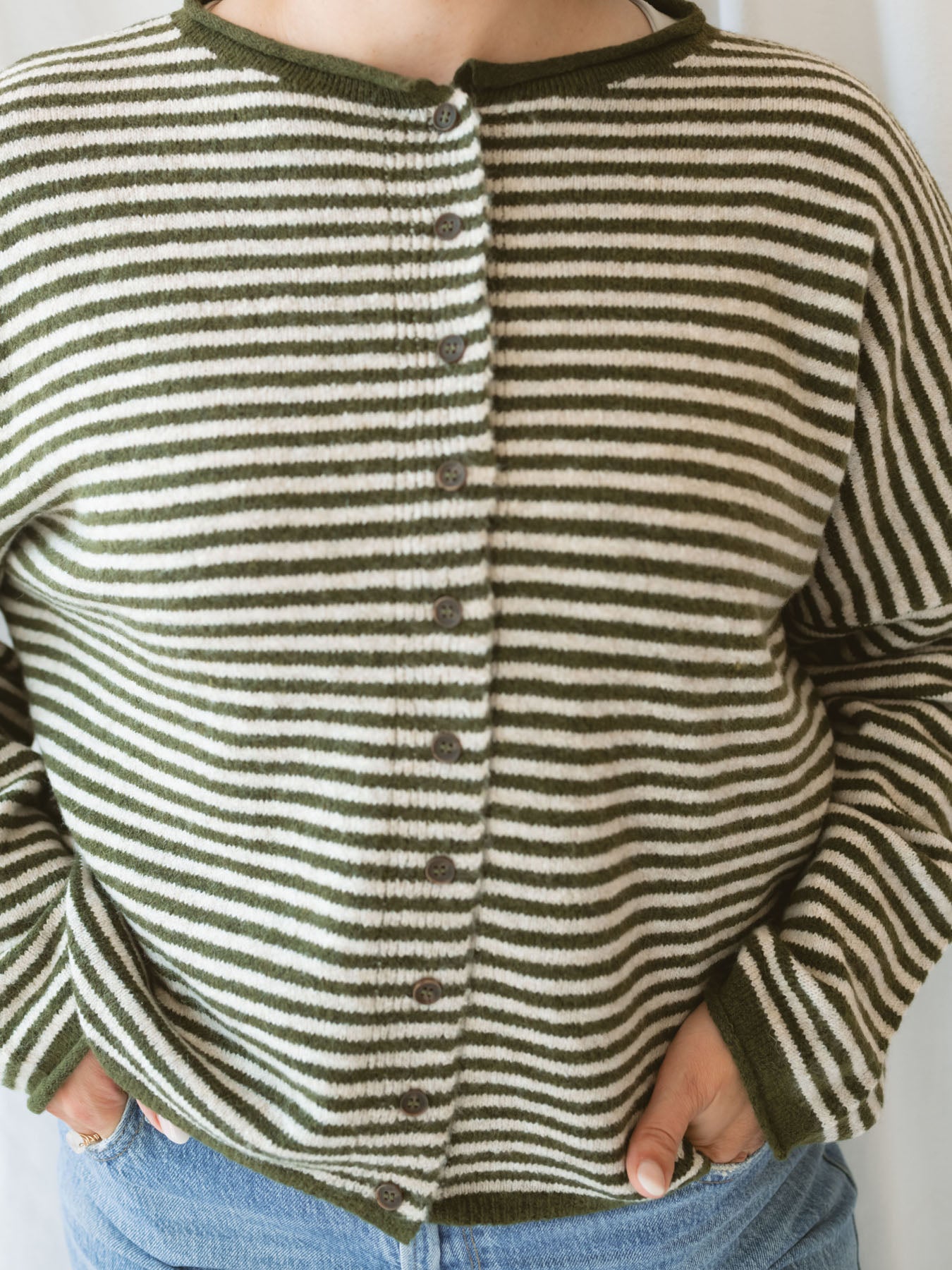 Model wearing striped full button cardigan. Styled fully buttoned up with a pair of classic denim. 